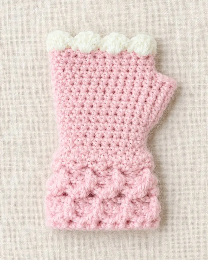 Child wearing a pink crochet wrist warmer